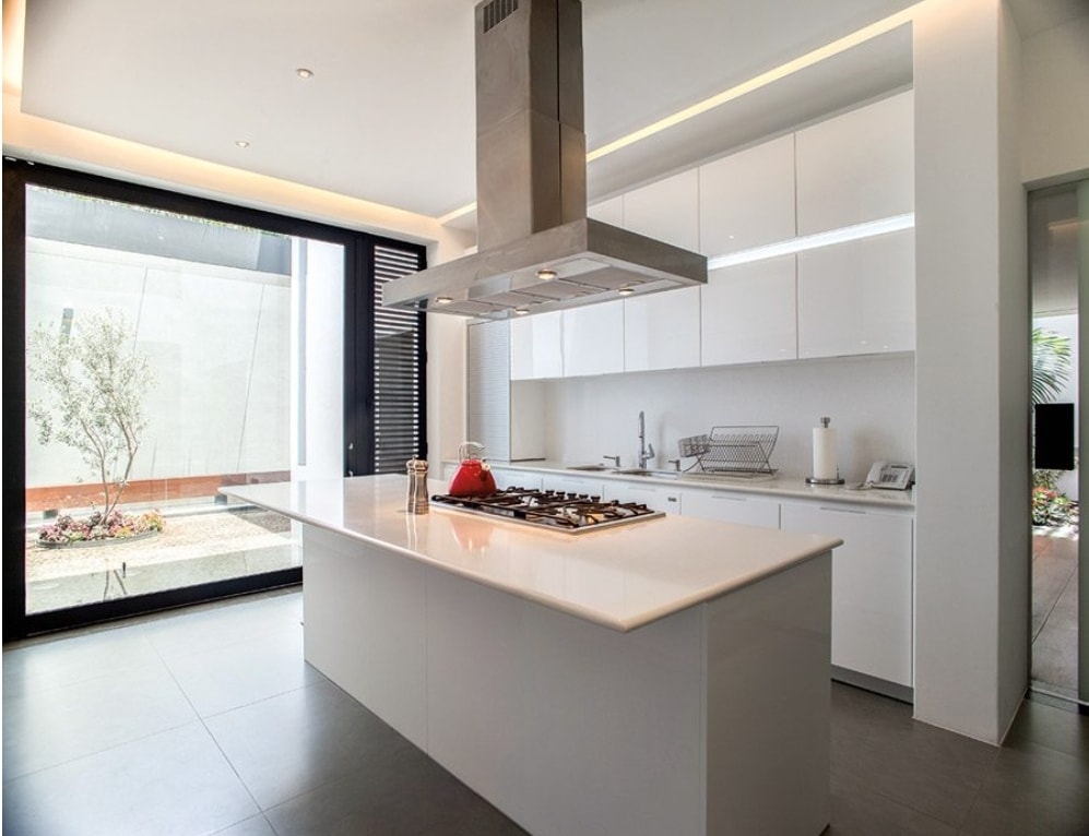 Cocina minimalista con isla central blanca